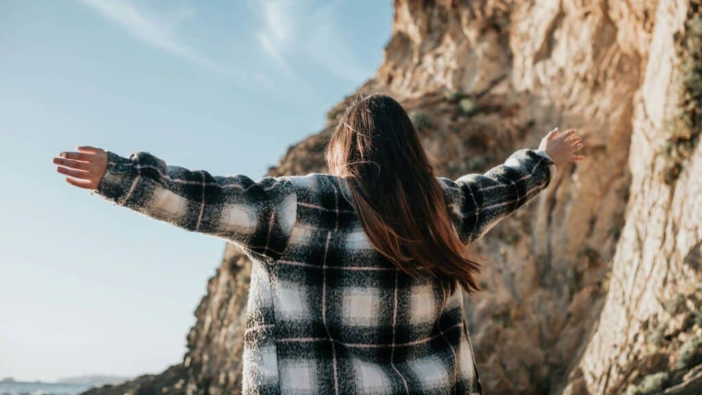A woman opening her arms to the skies conveys the message of the blog post titled "A Starting Point" by Robert Lauderdale.