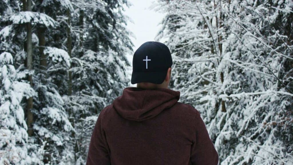 Christian Church in Sioux City Mt Zion Baptist church blog titled It Ain't About You shows man in winter forest wearing a hat with a cross on it.