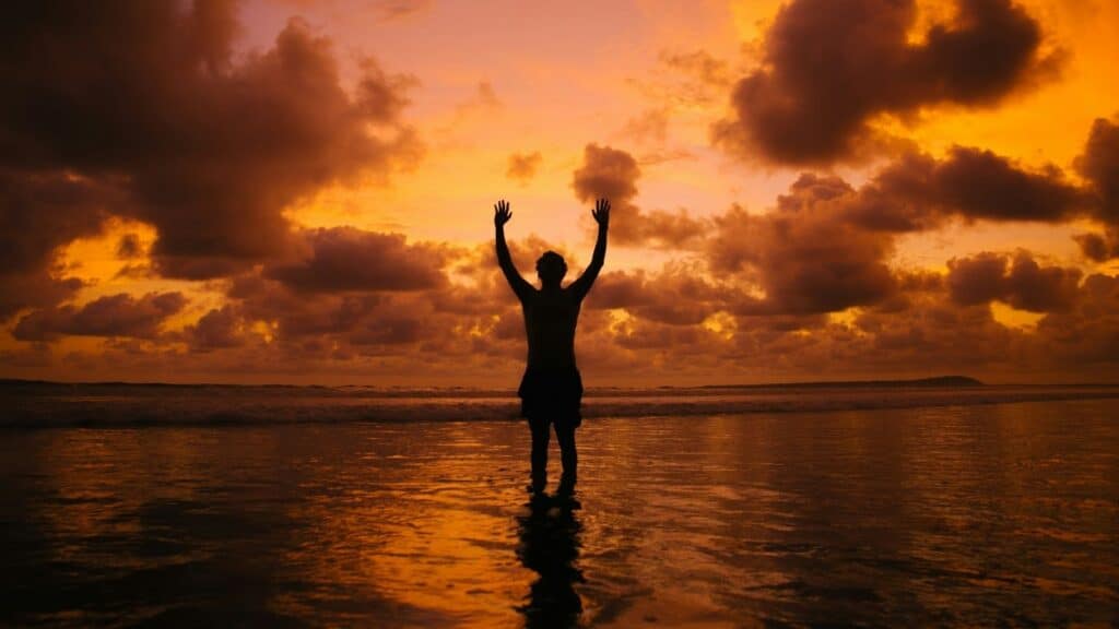 Man raising hands in gratitude to God for message I Owe Him This Praise from Psalm 103
