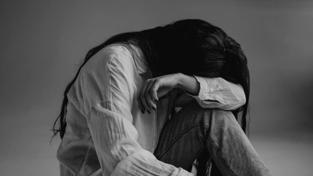 Woman crying silent cries from deep emotional wounds, crying out to God.