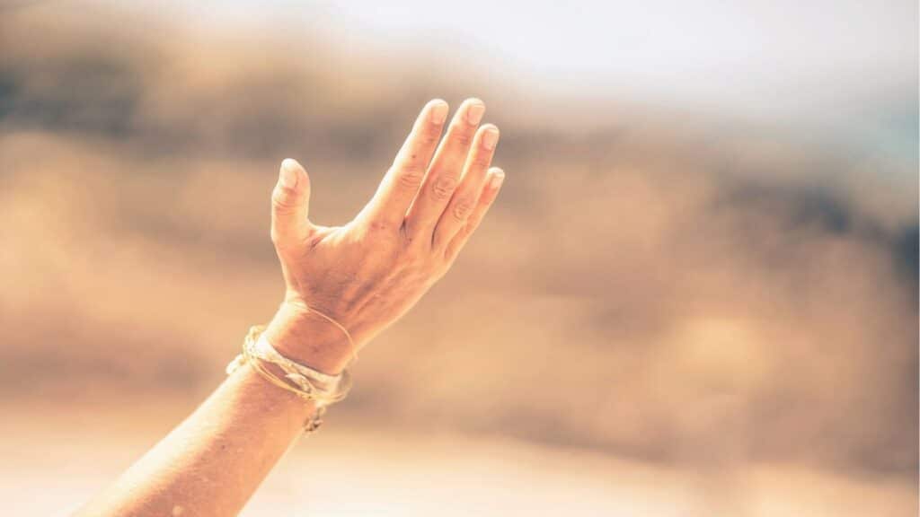 A person reaching forward in faith, symbolizing breakthrough and healing through Jesus