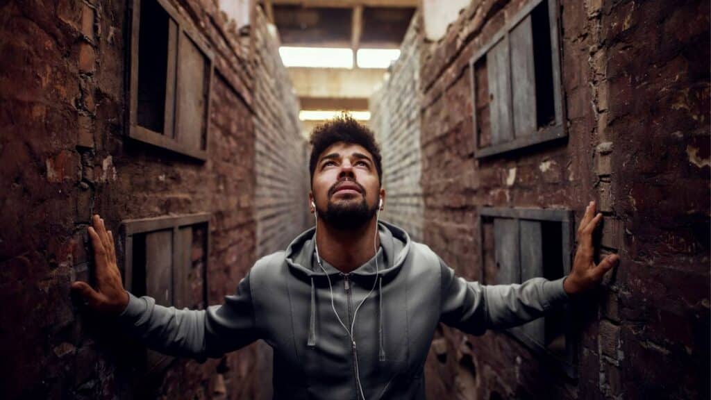 Man between two brick walls to convey break free of strongholds and a message of hope and encouragement